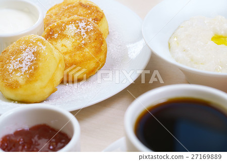 Set table with porridge cheesecakes coffee in cafe Set table with porridge cheesecakes coffee in cafe 27169889