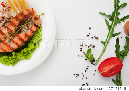 Grilled salmon steak on white table flat lay Grilled salmon steak on white table flat lay 27171546
