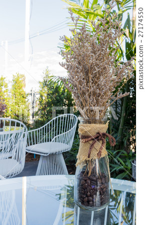 Dried flower in vase on glass table Dried flower in vase on glass table 27174550