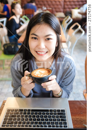 Business woman working on Laptop In Coffee Shop Business woman working on Laptop In Coffee Shop 27174756