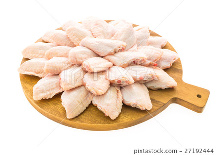 Raw chicken meat and wing on wooden cutting board or plate 27192444
