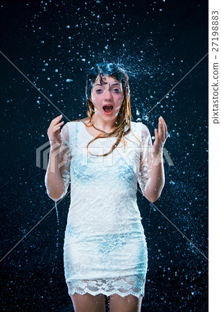 The young girl standing under running water 27198883