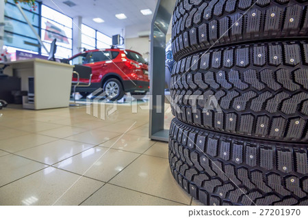 Winter tires in showroom of a car dealer Winter tires in showroom of a car dealer 27201970