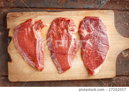 Raw beef steak on cutting board 27202057
