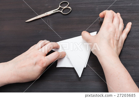 hands fold sheet of paper to make figure hands fold sheet of paper to make figure 27203685