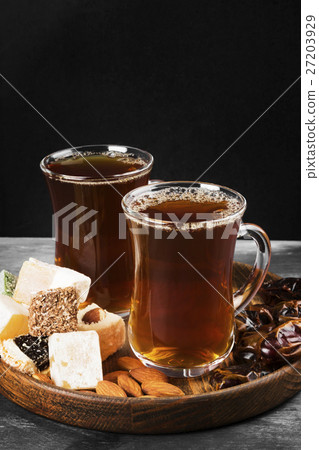 Black tea, oriental sweets, dates and nuts Black tea, oriental sweets, dates and nuts 27203929