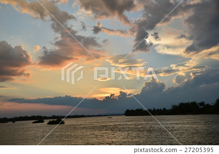 A boat that crosses the Mekong River and the sunset and the river from the Seapandundet in Laos 27205395