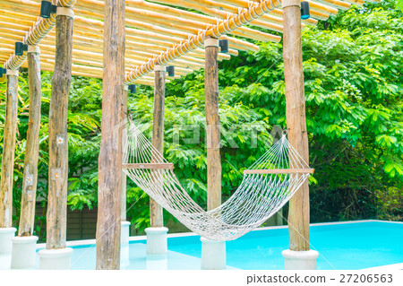White hammocks in Luxury swimming pool . 27206563