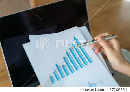 Business woman hand with Financial charts and laptop on the table . Business woman hand with Financial charts and laptop on the table . 27206754