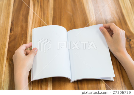Hands open book on wood table . Hands open book on wood table . 27206759