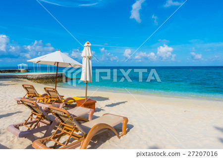 Beach chairs with umbrella at Maldives island with white sandy beach and sea . 27207016