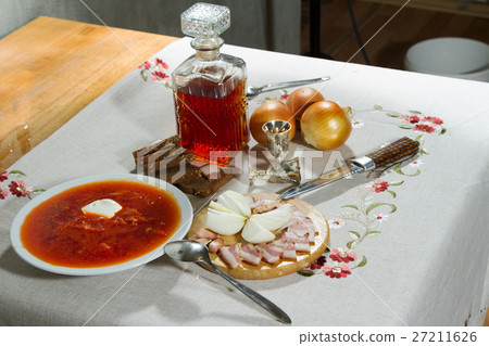 Carafe with alcohol tincture with snack stands on  27211626