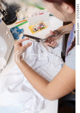 Woman cuts out with scissors Woman cuts out with scissors 27216341