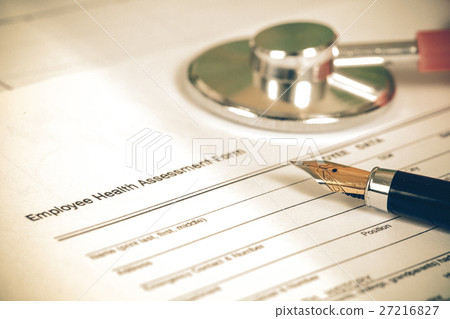 close up employee health assessment form and pen close up employee health assessment form and pen 27216827