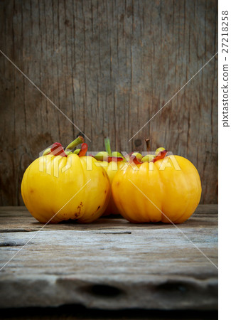 Garcinia cambogia fruit on wood background. 27218258