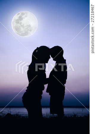 Silhouette side view of mother and child enjoying Silhouette side view of mother and child enjoying 27218467