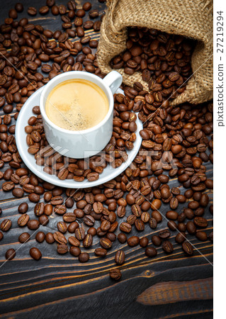cup of coffee and beans on wooden background cup of coffee and beans on wooden background 27219294