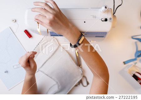 Woman with sewing-machine top view 27222195