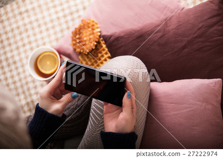 Above view of female hand holding smart phone with Above view of female hand holding smart phone with 27222974