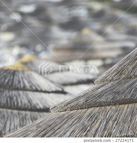 woven umbrellas above rows on beach in Cyprus. woven umbrellas above rows on beach in Cyprus. 27224171