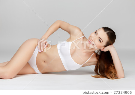 Perfect female legs on grey background Perfect female legs on grey background 27224906
