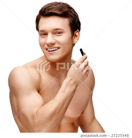 Handsome young man sniffing his armpit Handsome young man sniffing his armpit 27225548