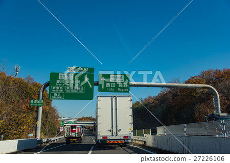 Truck going through the autumn main road soon Toki Junction 27226106