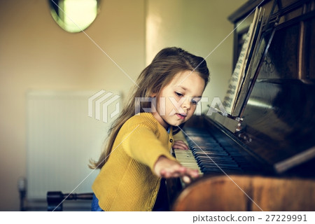 Adorable Cute Girl Playing Piano Concept Adorable Cute Girl Playing Piano Concept 27229991