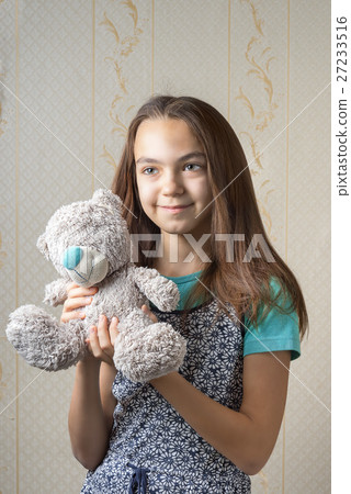 Portrait of a girl hugging a teddy bear 27233516
