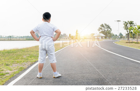 Obese fat boy exercise at park on morning 27233528