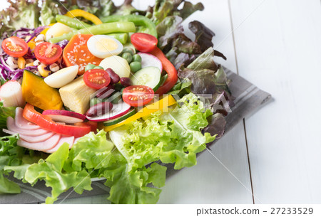 closed up of fresh mix vegetation salad on white wood. closed up of fresh mix vegetation salad on white wood. 27233529