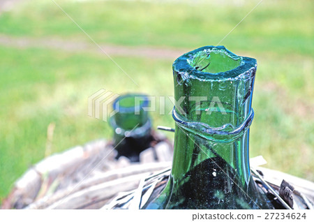 Old demijohn glass wrapped in wicker. Old demijohn glass wrapped in wicker. 27234624