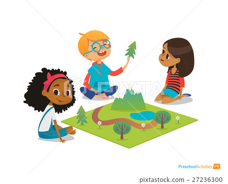 Children sitting on floor explore toy landscape 27236300