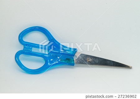 Blue scissors laying on the white paper 27236902
