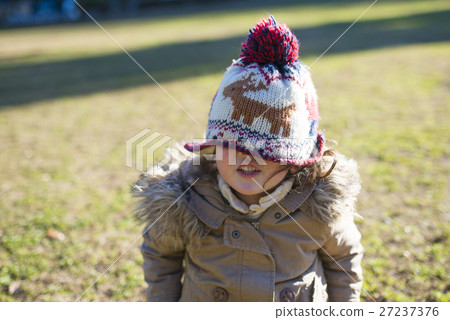 Girl hiding face with knit cap 27237376