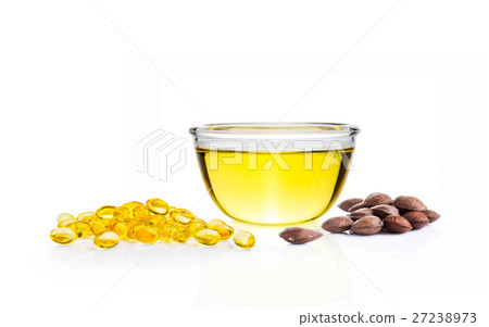 Yellow oil in glass bowl, gels, Sacha Inchi seeds Yellow oil in glass bowl, gels, Sacha Inchi seeds 27238973