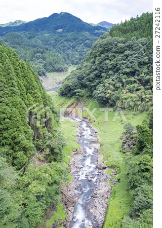 A beautiful hand surrounded by a green forest from the Murohara Bridge over the prefectural border of Kumamoto Prefecture and Oita Prefecture Look over the mountain stream valley of Mizuno River A beautiful hand surrounded by a green forest from the Murohara Bridge over the prefectural border of Kumamoto Prefecture and Oita Prefecture Look over the mountain stream valley of Mizuno River 27242116