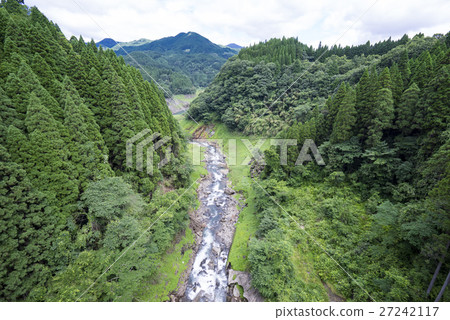 A beautiful hand surrounded by a green forest from the Murohara Bridge over the prefectural border of Kumamoto Prefecture and Oita Prefecture Look over the mountain stream valley of Mizuno River A beautiful hand surrounded by a green forest from the Murohara Bridge over the prefectural border of Kumamoto Prefecture and Oita Prefecture Look over the mountain stream valley of Mizuno River 27242117
