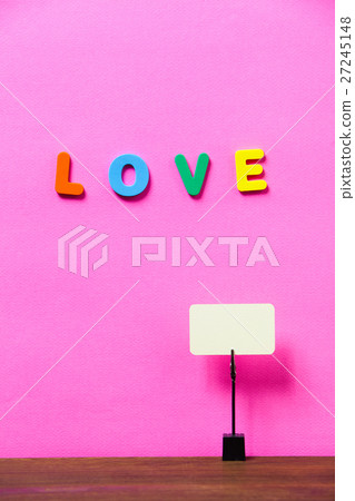 Paperclip hold blank card on a desk with letter LO 27245148