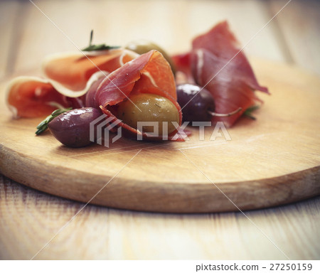 Prosciutto with olives and rosemary Prosciutto with olives and rosemary 27250159