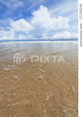 Waves sand beach and clouds sunny day Waves sand beach and clouds sunny day 27250240