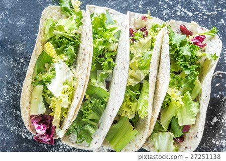 Four vegetarian tacos on a black background Four vegetarian tacos on a black background 27251138