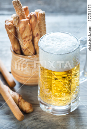 Glass of beer with breadsticks 27251873
