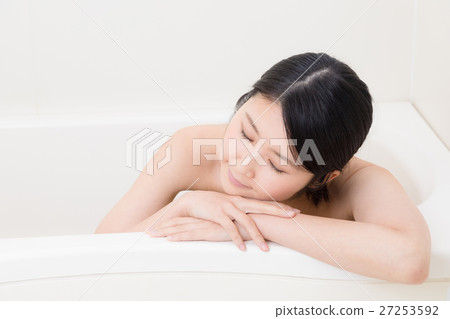 A woman taking a bath A woman taking a bath 27253592