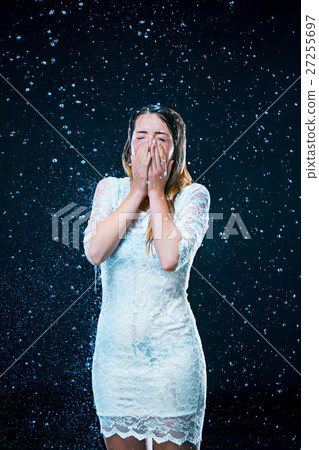 The young girl standing under running water The young girl standing under running water 27255697