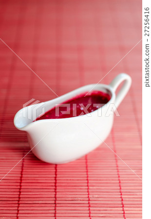Sauce boat with red sauce 27256416