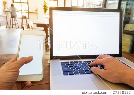 working using technology at coffee shop 27258152