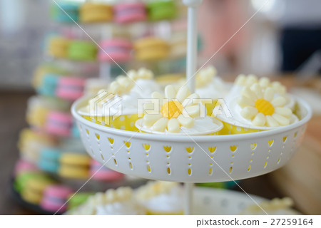 cupcakes with flower decorated on stand 27259164