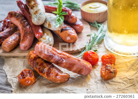 Grilled sausages with glass of beer 27260361