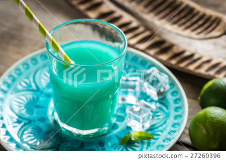 Glass of blue curacao and juice cocktail 27260396